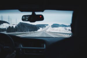 View of a snowy montain from inside an automobile
